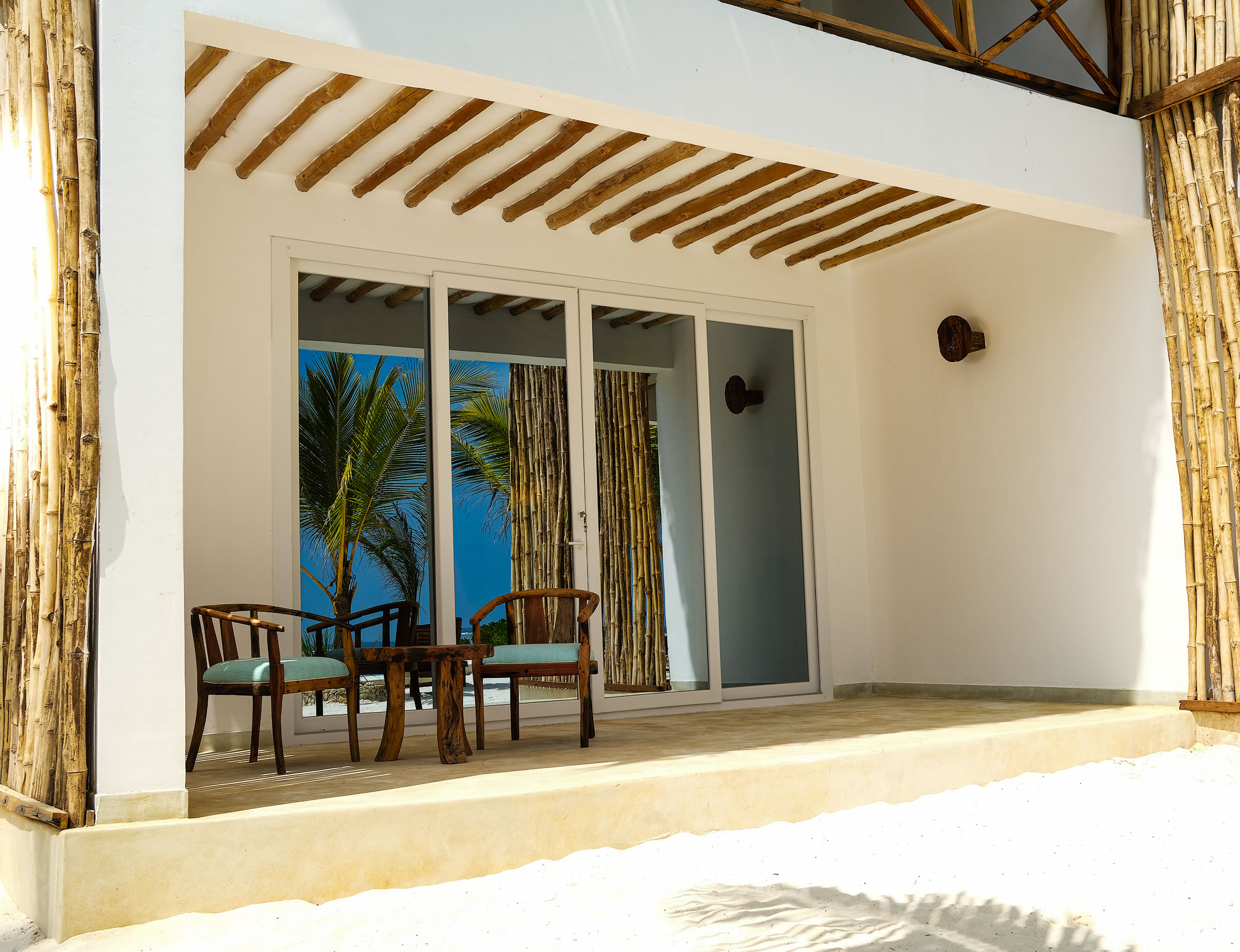 Triple Suite - terrace with windows mirroring the beach